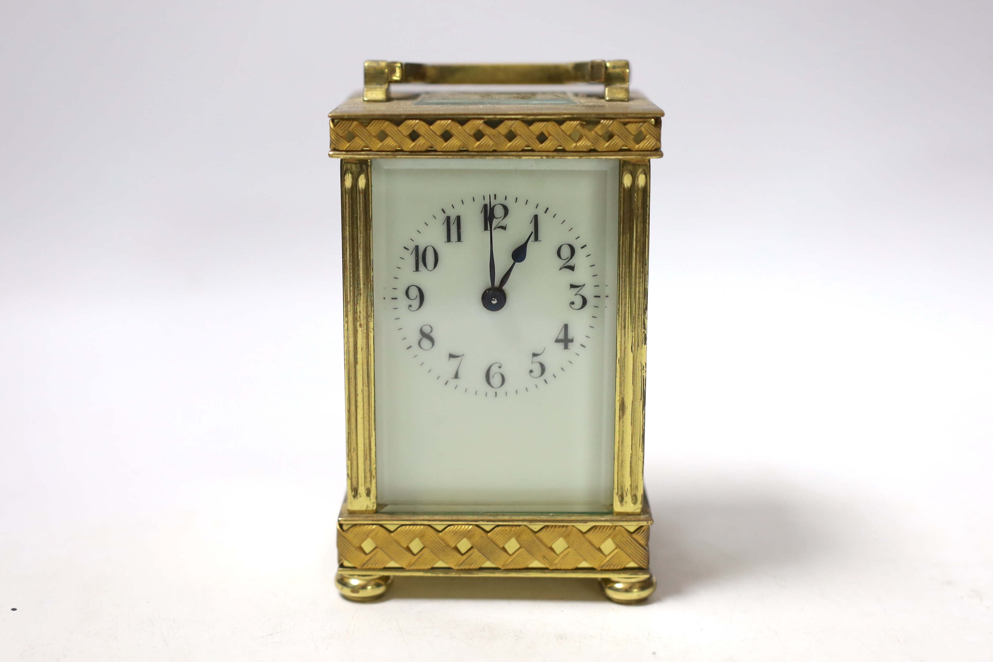 An Edwardian blind fretwork brass carriage timepiece, 12cm, in cloth covered case